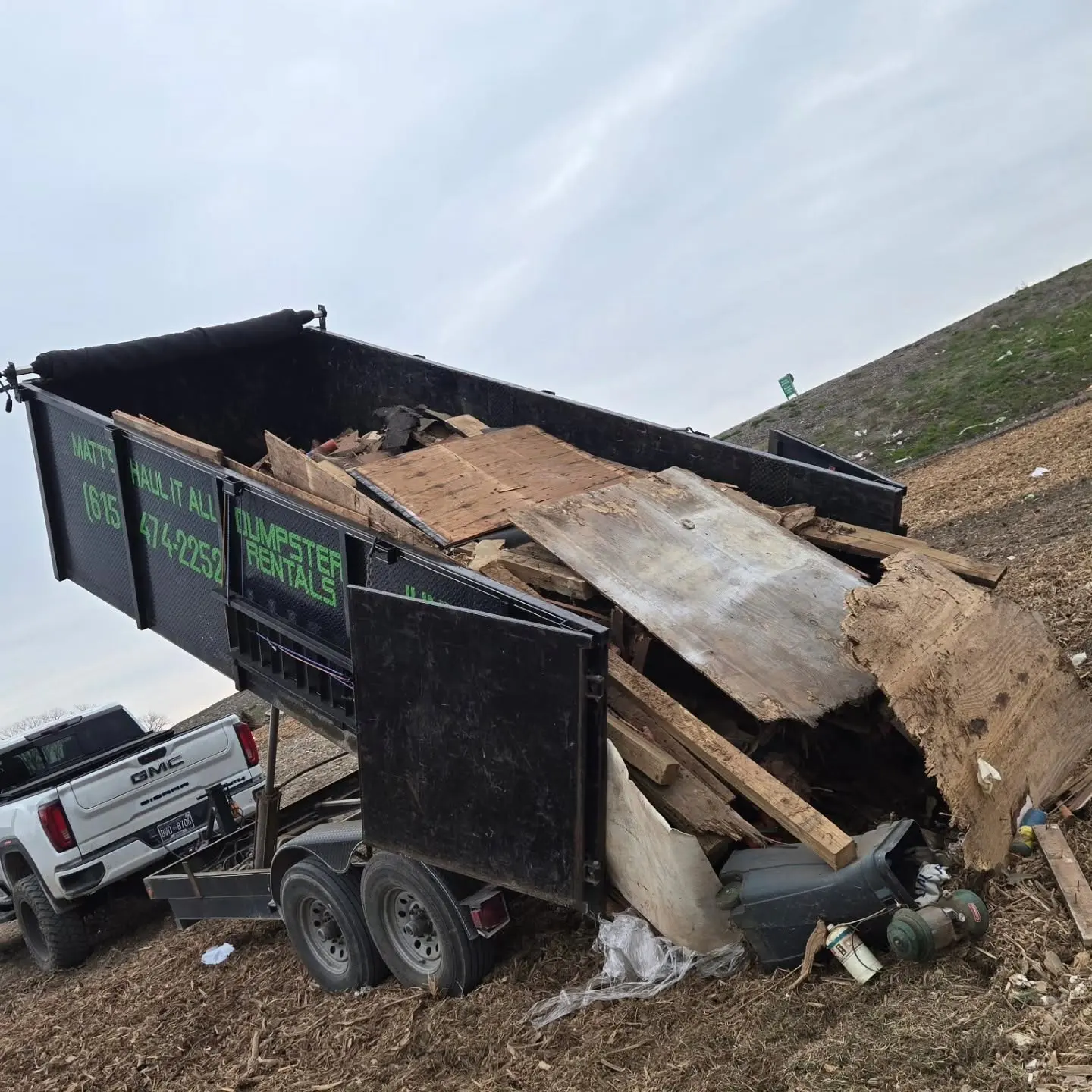 Dump trailer loaded with lumber and construction debris