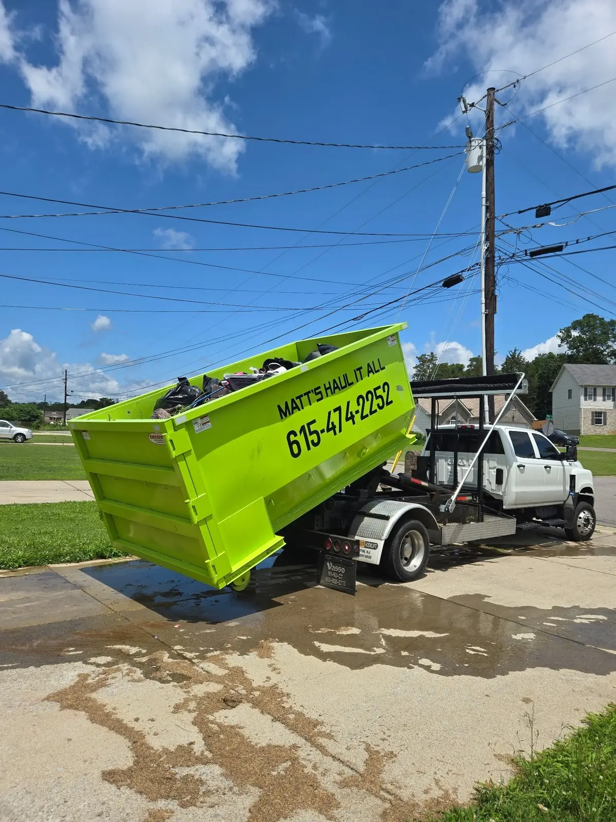 Roll-off truck picking up a dumpster