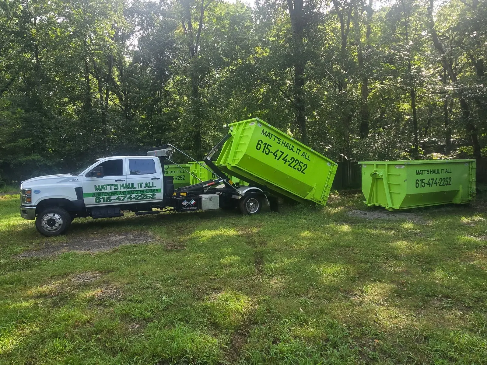 Roll-off truck delivering a 15-yard dumpster in Nashville, TN
