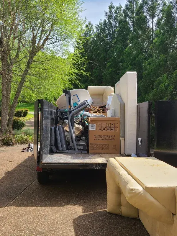 Trailer loaded with furniture during a junk removal cleanout